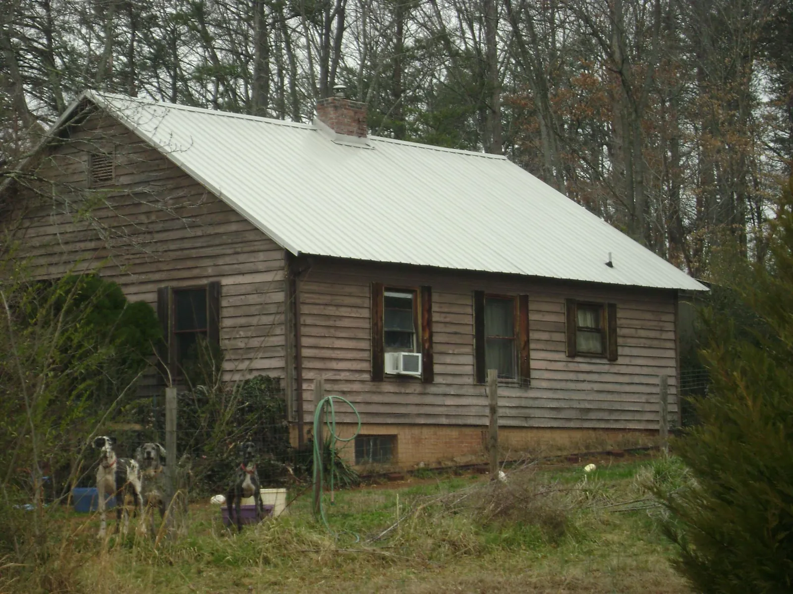 White metal roof on an old wood sided farmhouse, from a Metal Roof Installation job in Bath